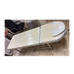 White Vinyl Padded Examination W/ Metal Legs, Adjustable Headrest Cushion. Fixed Price $100.00.
